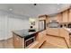 Bright kitchen boasts light wood cabinets, stainless steel appliances, a kitchen island, and hardwood flooring at 5105 Vernon Oaks Dr, Dunwoody, GA 30338