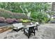 Stone patio area with outdoor seating and manicured landscaping, perfect for entertaining at 5105 Vernon Oaks Dr, Dunwoody, GA 30338
