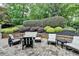 Landscaped backyard stone patio area featuring an outdoor seating and entertaining area at 5105 Vernon Oaks Dr, Dunwoody, GA 30338