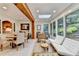 Sunroom with natural light, skylights, a wood beam, and views of the professionally landscaped backyard at 5105 Vernon Oaks Dr, Dunwoody, GA 30338