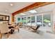 Sunroom with natural light, skylights, a wood beam, and views of the professionally landscaped backyard at 5105 Vernon Oaks Dr, Dunwoody, GA 30338