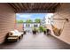 Relaxing covered balcony featuring a hammock, lounge bench, and a view of the city at 616 Angier Ne Ave # 4, Atlanta, GA 30308