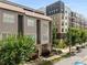 Three-story townhouse with a modern facade, well-maintained landscaping, and pedestrian sidewalk at 616 Angier Ne Ave # 4, Atlanta, GA 30308
