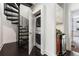 Hallway view of stacked laundry unit, spiral stairs, and wet bar at 616 Angier Ne Ave # 4, Atlanta, GA 30308