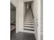 Hallway view with black and white staircase, gray tile floors, and neutral wall paint at 616 Angier Ne Ave # 4, Atlanta, GA 30308