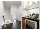 View of an elegant hallway with a wet bar, sleek black floors, and stairs leading to a lower level at 616 Angier Ne Ave # 4, Atlanta, GA 30308