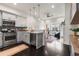 Modern kitchen open to the living area, featuring gray cabinetry, stainless appliances, and hardwood flooring at 616 Angier Ne Ave # 4, Atlanta, GA 30308