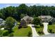 Aerial view of a beautiful home with a manicured lawn, driveway, and lush landscaping at 650 Chestatee Creek Nw Dr, Acworth, GA 30101