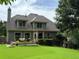 Backyard featuring a well-maintained lawn, deck with outdoor furniture, and lush landscaping, creating a serene outdoor space at 650 Chestatee Creek Nw Dr, Acworth, GA 30101