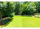 Large, well-maintained backyard featuring a fire pit area and fenced perimeter at 650 Chestatee Creek Nw Dr, Acworth, GA 30101