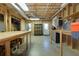 Unfinished basement features exposed ceiling, concrete flooring, utility shelving, and a door to the exterior at 650 Chestatee Creek Nw Dr, Acworth, GA 30101