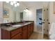 Double vanity bathroom with granite countertops and cherry cabinets located just off the bonus room at 650 Chestatee Creek Nw Dr, Acworth, GA 30101
