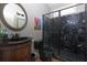 Bathroom with a walk-in shower featuring black marble tile, and a vanity with a black sink at 650 Chestatee Creek Nw Dr, Acworth, GA 30101