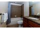 Bathroom featuring a bathtub with tiled shower and a granite topped vanity with cherry cabinets at 650 Chestatee Creek Nw Dr, Acworth, GA 30101