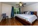 Bright bedroom with hardwood floors, ceiling fan, and a large window overlooking the backyard at 650 Chestatee Creek Nw Dr, Acworth, GA 30101