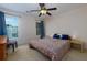 Comfortable bedroom with neutral carpet, a ceiling fan, and bright windows providing natural light at 650 Chestatee Creek Nw Dr, Acworth, GA 30101