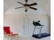 Attic bonus room offering a vaulted ceiling, carpeted floor, and fan with a treadmill and a red chair at 650 Chestatee Creek Nw Dr, Acworth, GA 30101