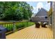 Inviting deck with wooden railing, green lawn, chairs, and lush trees in the background at 650 Chestatee Creek Nw Dr, Acworth, GA 30101