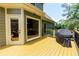 Relaxing deck view with grill, wooden railing, door, and exterior of the home at 650 Chestatee Creek Nw Dr, Acworth, GA 30101