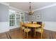 Bright dining room with an elegant chandelier, hardwood floors, and natural light from large windows at 650 Chestatee Creek Nw Dr, Acworth, GA 30101