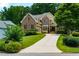 Elegant two-story brick home with a manicured lawn and a long driveway, showcasing curb appeal and charm at 650 Chestatee Creek Nw Dr, Acworth, GA 30101