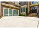 Exterior view with a green garage door and beautiful front door of an upscale residence at 650 Chestatee Creek Nw Dr, Acworth, GA 30101