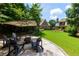 Backyard fire pit with Adirondack chairs on a stone patio surrounded by lush greenery at 650 Chestatee Creek Nw Dr, Acworth, GA 30101