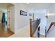 Upstairs hallway boasts fresh paint, plush carpet, and decorative wood railing leading to the lower level at 650 Chestatee Creek Nw Dr, Acworth, GA 30101