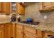 Kitchen featuring custom cabinets, granite countertops, gas cooktop, and stainless steel appliances at 650 Chestatee Creek Nw Dr, Acworth, GA 30101