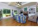 Comfortable living room with large windows, hardwood flooring, a brick fireplace, and custom built-ins at 650 Chestatee Creek Nw Dr, Acworth, GA 30101