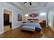 Comfortable main bedroom with tray ceilings, hardwood floors, and plenty of natural light at 650 Chestatee Creek Nw Dr, Acworth, GA 30101