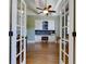 Office/study room featuring built-in cabinetry, a ceiling fan, and wood floors at 650 Chestatee Creek Nw Dr, Acworth, GA 30101