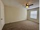 Bedroom with plush carpeting, ceiling fan, and ample natural light at 1343 Old Coach Sw Rd, Marietta, GA 30008