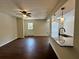 Open living room with hardwood floors, ceiling fan, and access to kitchen at 1343 Old Coach Sw Rd, Marietta, GA 30008