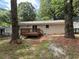 Backyard view with a small deck, nice windows and trees at 2943 Westbury Dr, Decatur, GA 30033
