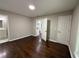 Bedroom with dark hardwood floors and neutral paint, featuring doorways to the bathroom and other rooms at 2943 Westbury Dr, Decatur, GA 30033