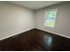 Bedroom features hardwood floors, natural light from a window, and neutral paint at 2943 Westbury Dr, Decatur, GA 30033