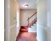 Warm entryway featuring hardwood floors and staircase with carpet runner at 2983 Trotters View Way, Snellville, GA 30039