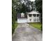 Charming two-story home with attached garage surrounded by mature trees and front lawn at 2983 Trotters View Way, Snellville, GA 30039