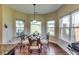 Bright dining area features large windows, wood floors, and stylish furnishings at 609 Turnbill Dr, Mcdonough, GA 30252