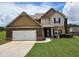 Charming two-story home featuring a well-manicured lawn and attached two-car garage at 609 Turnbill Dr, Mcdonough, GA 30252