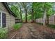 Backyard with a wooded perimeter and a partial view of the side of the house at 778 Mclendon Dr, Decatur, GA 30079