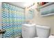 Well-lit bathroom featuring a vanity and a shower with a patterned curtain at 778 Mclendon Dr, Decatur, GA 30079
