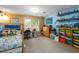 Spacious bedroom with wood-paneled and blue walls, natural light, and organized storage shelves at 778 Mclendon Dr, Decatur, GA 30079