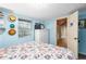 Bright bedroom featuring a window, a dresser, a floral patterned bed, and an adjacent doorway at 778 Mclendon Dr, Decatur, GA 30079