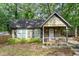 Charming cottage-style home with a cozy front porch and well-maintained landscaping at 778 Mclendon Dr, Decatur, GA 30079