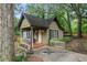 Charming cottage-style home nestled among mature trees and a white picket fence at 778 Mclendon Dr, Decatur, GA 30079