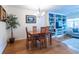 Dining space includes wood floors, a modern chandelier, and built-in shelving in the adjacent living room at 104 Powell Cv, Decatur, GA 30030