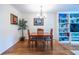 Dining space includes wood floors, a modern chandelier, and built-in shelving in the adjacent living room at 104 Powell Cv, Decatur, GA 30030