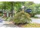 A welcoming entrance to the Swanton Hill community with lush landscaping and a decorative sign at 104 Powell Cv, Decatur, GA 30030